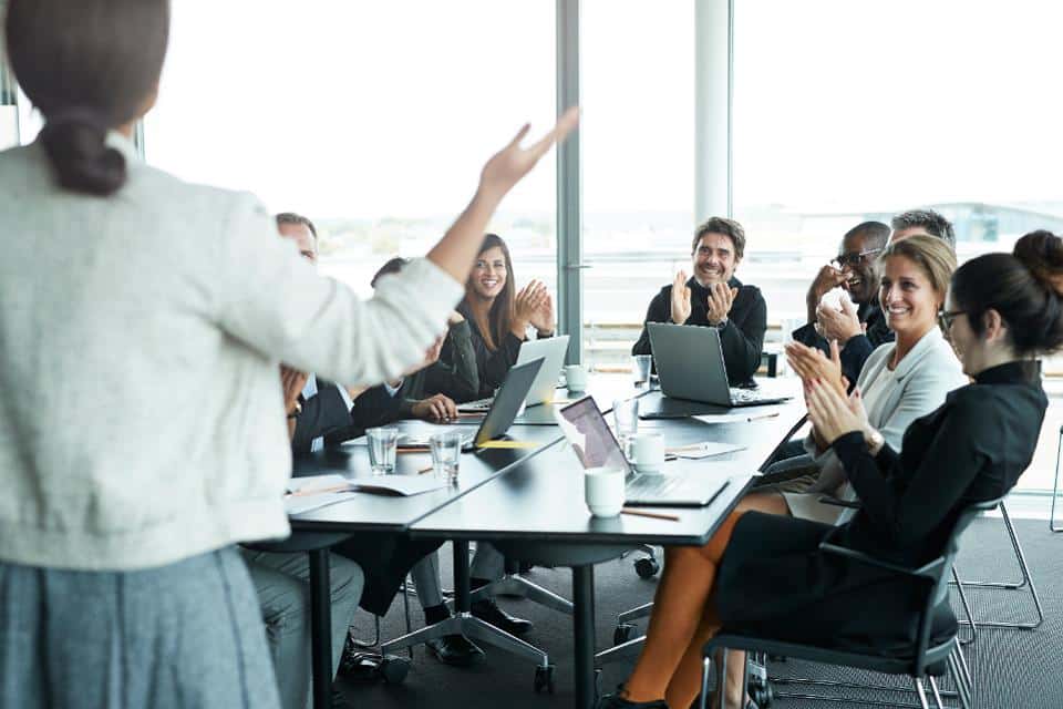 Business people in large modern meeting room